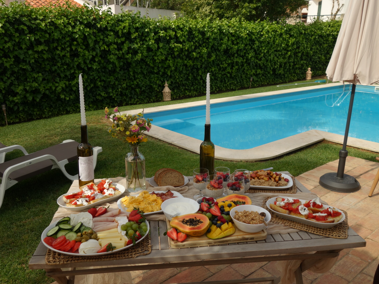 Breakfast table set beside the pool